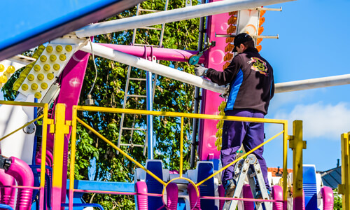 man working on amusement park ride